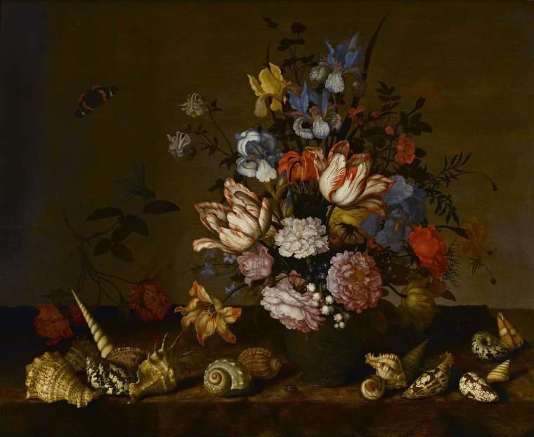 A vase of flowers with shells on a ledge