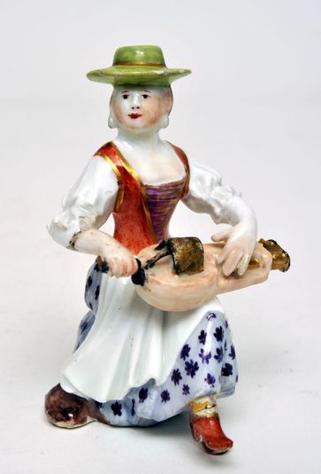 Figure: Woman playing a Hurdy-Gurdy