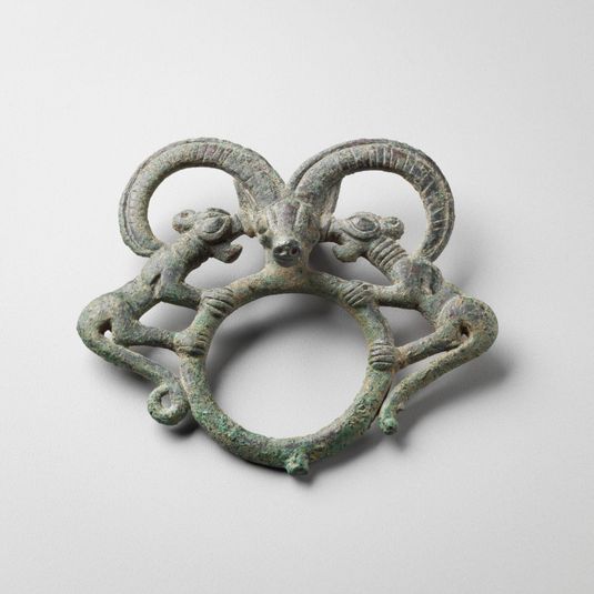 Harness Ring with a Mountain Goat Head (center) and Lions