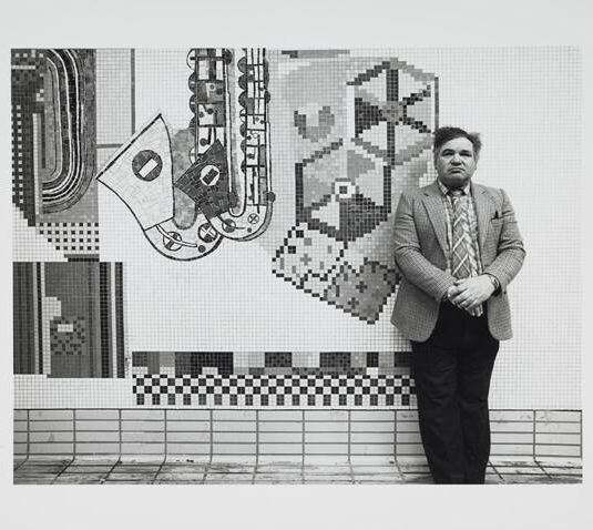 Black and white print of Eduardo Paolozzi standing in front of Tottenham Court Road mosaics in situ. Inscribed 'Frontispiece' on verso (2 x duplicates)