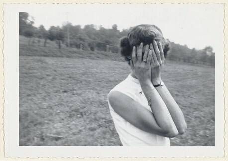 Untitled (Woman with hands over face in field)