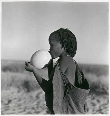 Bushman Girl Using Ostrich Egg as Water Bottle, Kalahari Desert, 1947