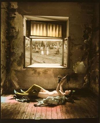 From Cradle to Grave (girl laying on floor with doll, cemetery in window)