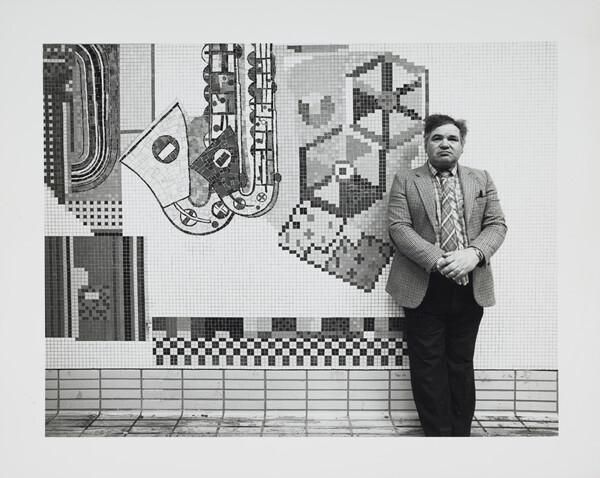 Black and white print of Eduardo Paolozzi standing in front of Tottenham Court Road mosaics in situ. Inscribed 'Frontispiece' on verso (2 x duplicates)
