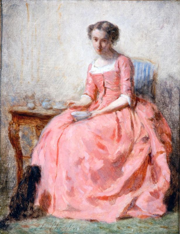 Girl in a Pink Dress sitting at a table reading, with dog