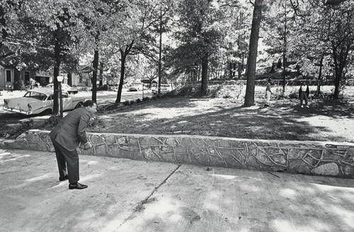In the front yard of his Atlanta home, Dr. King takes time out for a game of catch with his sons