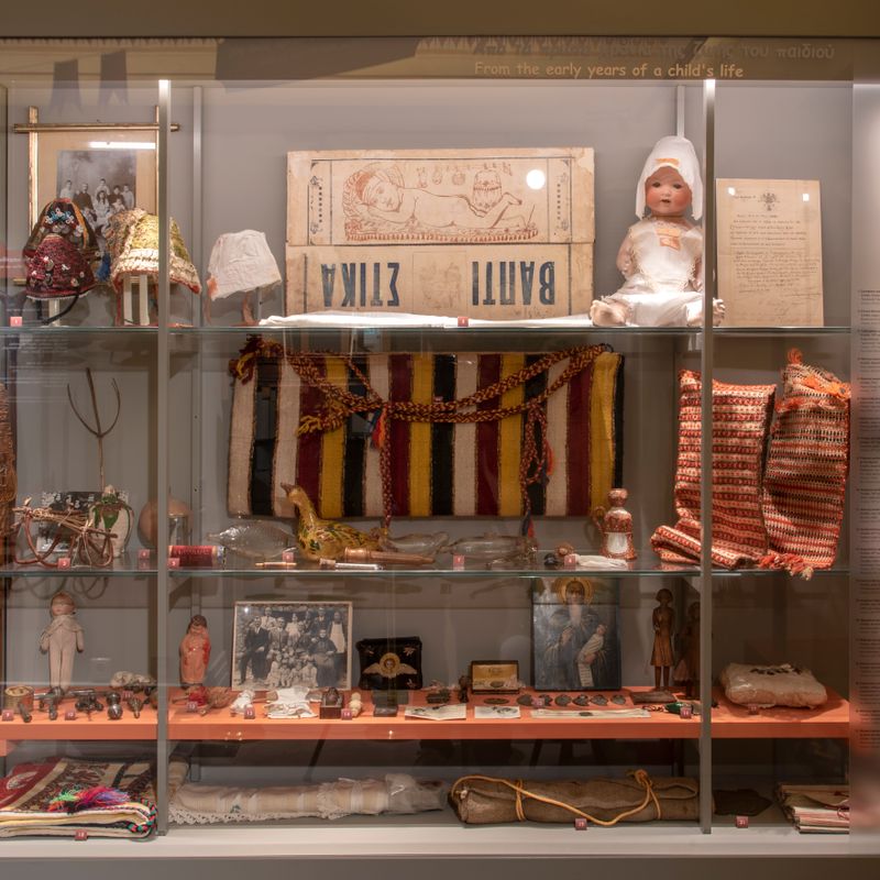 Koutsounes, dolls and wooden toys in the display case