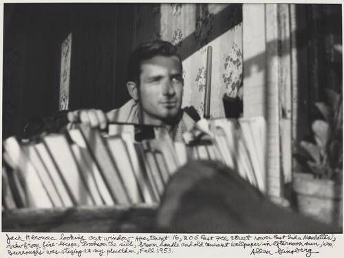 Jack Kerouac looking out window Apartment 16, 206 East 7th Street Lower East Side Manhattan, view from fire-escape, books on the sill, broom handle and old tenement wallpaper in afternoon sun, WM. Burroughs was staying at my place then, Fall 1953.