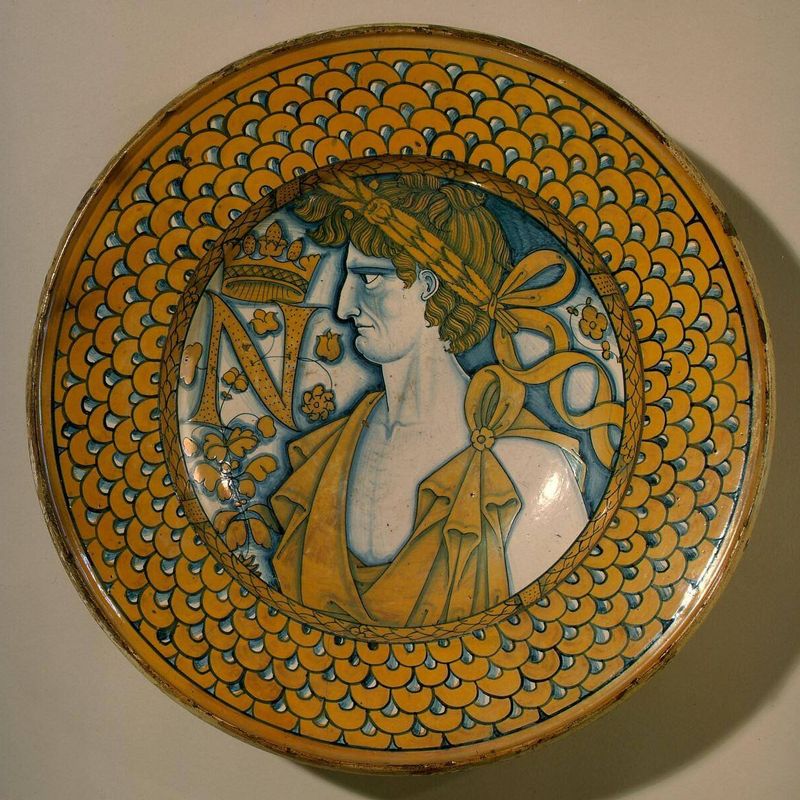 Large dish with scale border; in the center, an imperial Roman figure and the letter N crowned