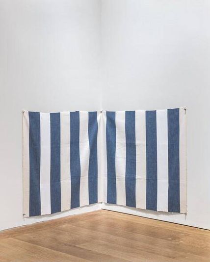 White acrylic paint on white and blue striped cloth