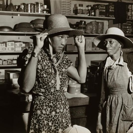 Trying on a new straw hat in Mr. M. W. Lipford's general store in Franklin, Heard County, Georgia