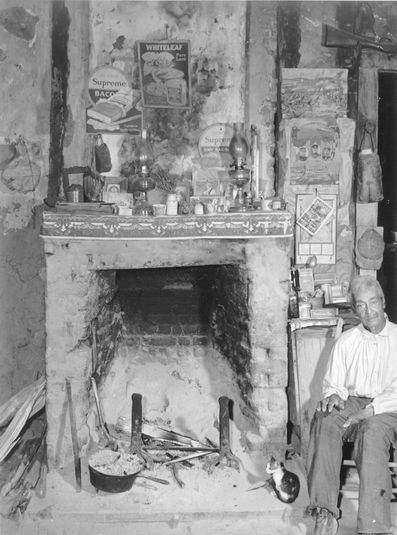A fireplace in an old mud hut which was built and is still lived in by a French-mulatto family, near the John Henry plantation. Melrose, Louisiana