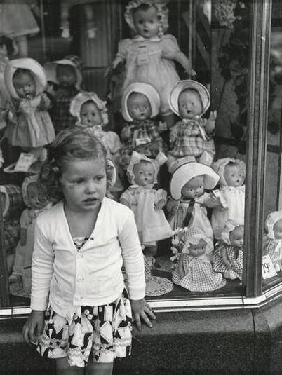 Girl in front of Doll Shop Window