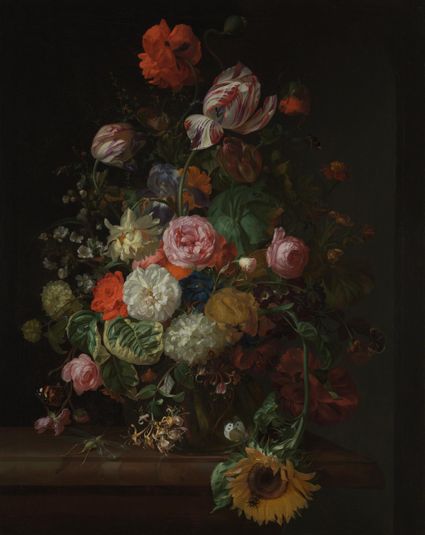 Still life of roses, tulips, a sunflower and other flowers in a glass vase with a bee, butterfly and other insects upon a marble ledge